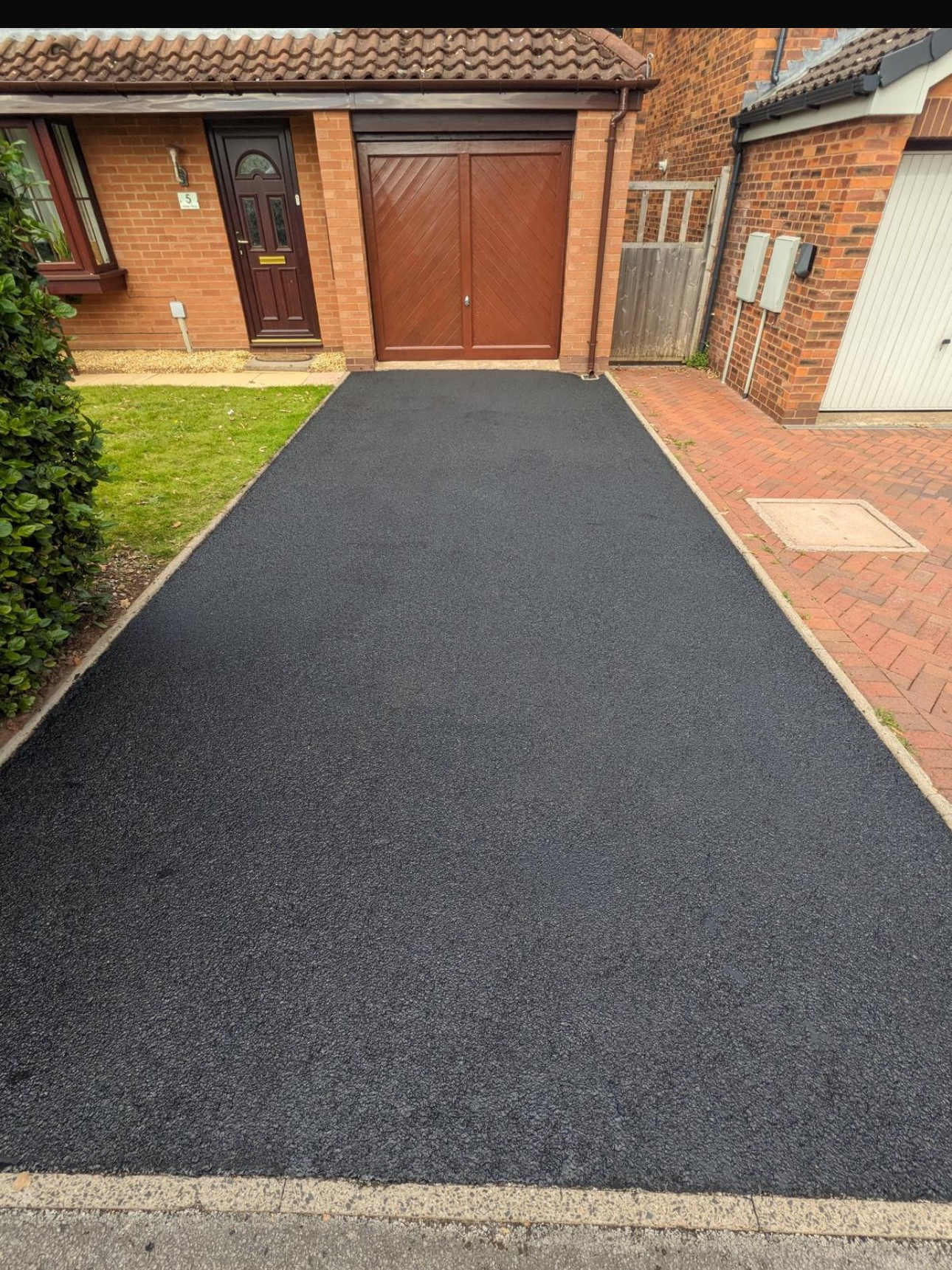 Tarmac driveway after jet washing — deep clean black finish restored