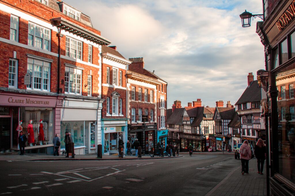Picturesque street view of Shrewsbury's historic architecture under afternoon sun.